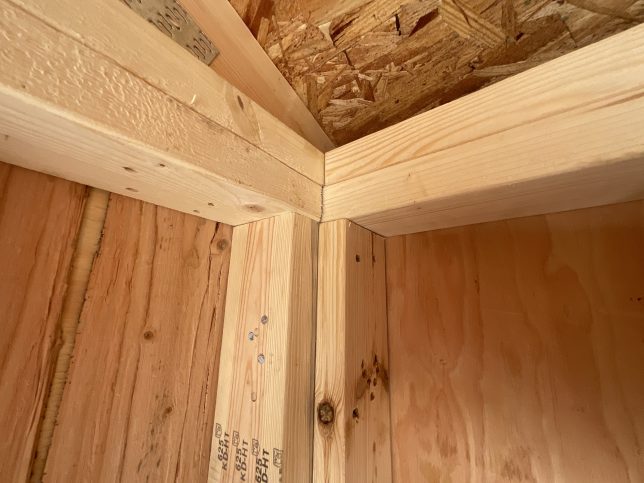 Double interlocking corner framing inside portable storage shed