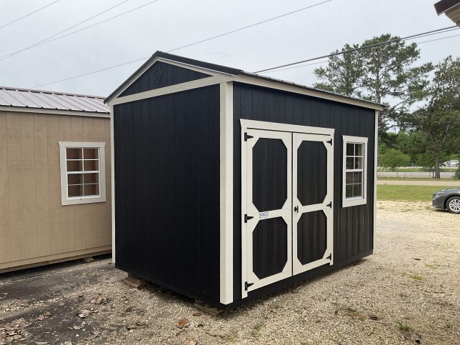 Portable storage shed with black siding and metal roof in Covington LA