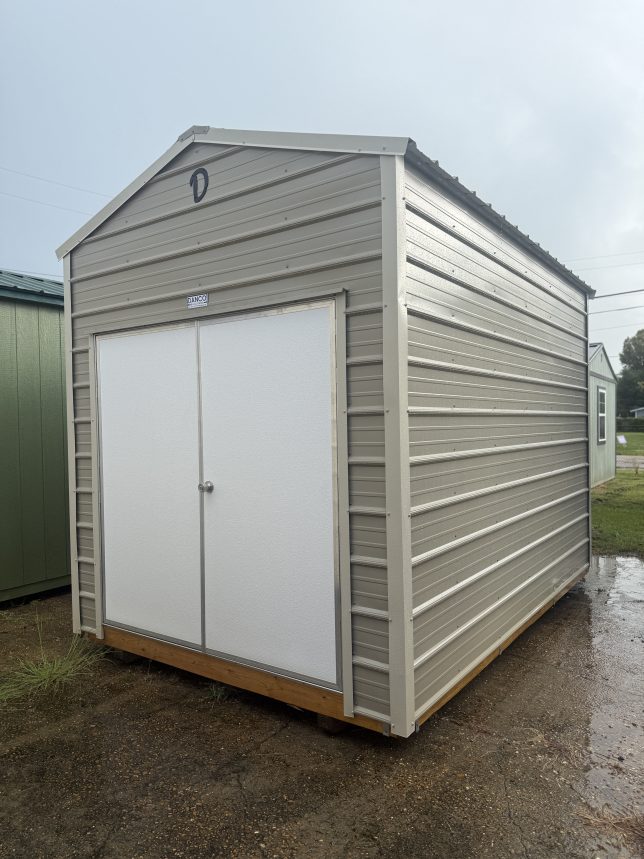 New 8×12 metal utility shed with Desert siding, Light Stone trim, and double doors at Johnson Portable Buildings in Covington, LA.