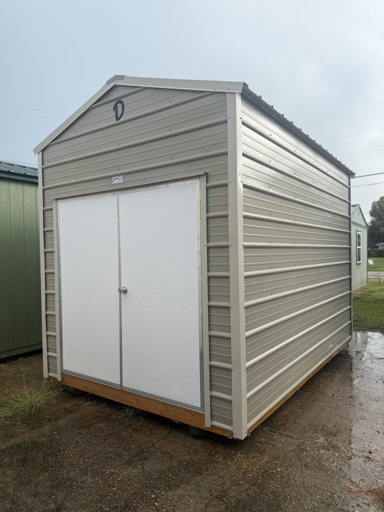 New 8×12 metal utility shed with Desert siding, Light Stone trim, and double doors at Johnson Portable Buildings in Covington, LA.
